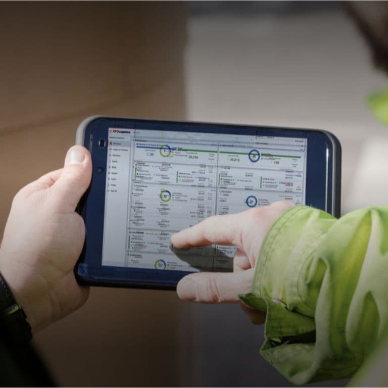 Hand holding tablet with shipping data